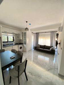 a living room with a table and a couch at Doğan Homes Likya in Demre