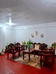 a living room with a couch and a table and chairs at Bert's Place in San Isidro