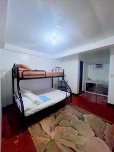a room with two bunk beds and a rug at Bert's Place in San Isidro
