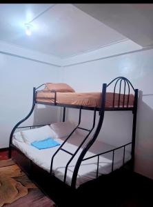 a couple of bunk beds in a room at Bert's Place in San Isidro