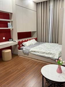 a small bedroom with a bed and a table at H3 ocean park 1 in Gia Lâm Pho
