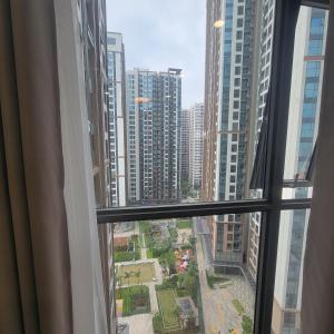 a window view of a city with tall buildings at H3 ocean park 1 in Gia Lâm Pho