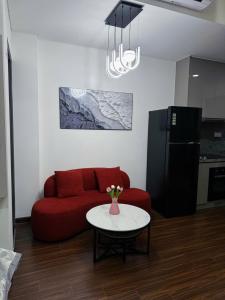 a living room with a red couch and a table at H3 ocean park 1 in Gia Lâm Pho
