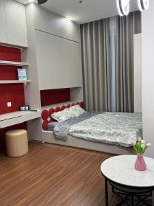 a small bedroom with a bed and a table at H3 ocean park 1 in Gia Lâm Pho