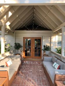 a screened porch with couches and a wooden door at Napa Farmhouse Inn in St. Helena +21 photos