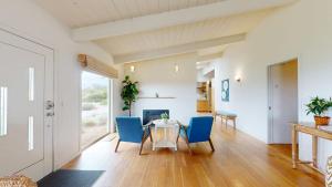a dining room with a table and blue chairs at Dream Scape in Fort Bragg