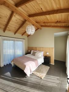 a bedroom with a large bed and a chandelier at Estancia del Sol in Putúe +22 photos