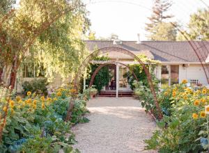 an archway in a garden in front of a house at Napa Farmhouse Inn in St. Helena