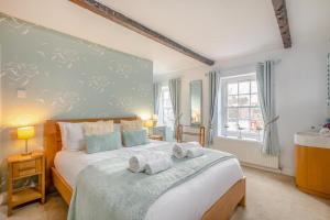 a bedroom with a large bed with towels on it at 3 Bed in Thornham oc-983 in Thornham