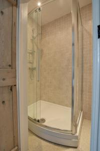 a shower with a glass door in a bathroom at 3 Bed in Thornham oc-983 in Thornham +17 photos