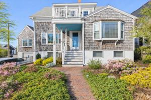 a house with a porch and a balcony at West End Haven w/ Modern Kitchen + Private Yard in Provincetown