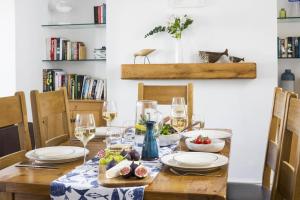a table with glasses of wine and food on it at 3 Bed in Porthleven oc-12bayv in Porthleven +15 photos