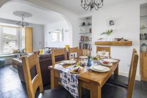 a dining room and living room with a table and chairs at 3 Bed in Porthleven oc-12bayv in Porthleven