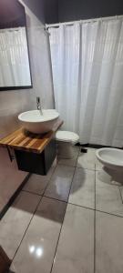 a bathroom with a sink and a toilet at Departamento luminoso con balcón in La Plata +19 photos