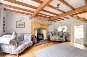 a living room with two couches and a fireplace at 2 Bed in Scarborough oc-sa003 in Ravenscar