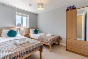 a bedroom with two beds and a dresser at 3 Bed in Felixstowe oc-p29748 in Felixstowe