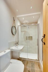 a white bathroom with a shower and a sink at 2 Bed in Danby oc-wa315 in Castleton +20 photos
