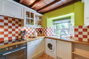 a kitchen with a sink and a washing machine at 2 Bed in Thwaite oc-ds946 in Thwaite +8 photos