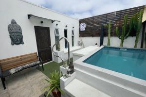 a swimming pool in the backyard of a house at Tayka Suite in La Serena