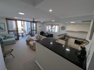 a kitchen and living room with a large counter top at Myconos Resort in Maroochydore