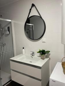 a white bathroom with a sink and a mirror at Casa das Andorinhas - AL in Castelo de Vide +28 photos