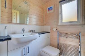 a bathroom with a sink and a toilet at 2 Bed in Weybourne oc-1628 in Kelling +4 photos