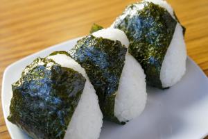 three pieces of sushi on a plate on a table at ANFT-shiro in Azumino