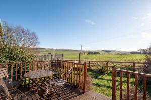 a wooden deck with a table and a fence at 2 Bed in Chatton oc-nb620 in Chatton +5 photos