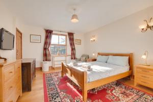 a bedroom with a bed and a red rug at 2 Bed in Chatton oc-nb620 in Chatton