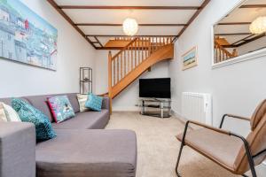 a living room with a couch and a television at 2 Bed in Padstow oc-p00398 in Saint Merryn