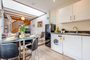 a kitchen and dining room with a table and a dishwasher at 2 Bed in Padstow oc-p00398 in Saint Merryn +15 photos