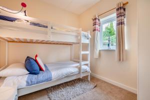 a bedroom with two bunk beds and a window at 2 Bed in Padstow oc-p00398 in Saint Merryn
