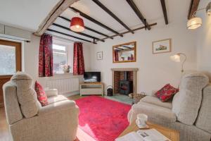 a living room with two couches and a red rug at 2 Bed in Gayle oc-ds912 in Hawes