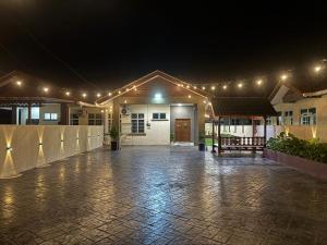 a lit up courtyard with lights on a building at Paradise Homestay Marang in Marang