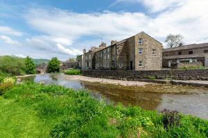 an old stone building next to a river at 2 Bed in Gayle oc-ds912 in Hawes