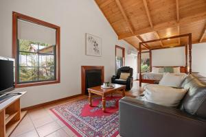 a living room with a couch and a fireplace at Mountainside Villa One in Halls Gap