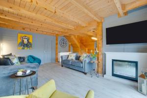 a living room with a couch and a flat screen tv at 4 Bed in Wadebridge oc-p00066 in Little Petherick