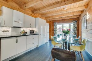 a kitchen with white cabinets and a table and chairs at 4 Bed in Wadebridge oc-p00066 in Little Petherick