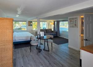 a bedroom with a bed and a table and chairs at Oasis Palms Resort in St. Pete Beach +79 photos