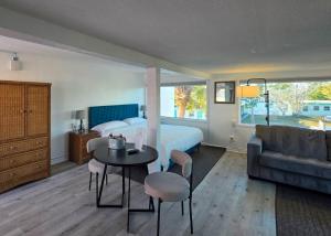 a bedroom with a bed and a table and a couch at Oasis Palms Resort in St. Pete Beach