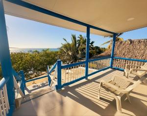 a porch with a chair and a view of the beach at Tintipan Hotel in Tintipan Island