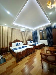 a hotel room with two beds and a table at Cozy 86 Homestay in Can Tho +49 photos