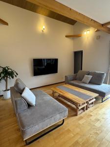 a living room with a couch and a coffee table at SerenityBlueAmami in Tatsugo