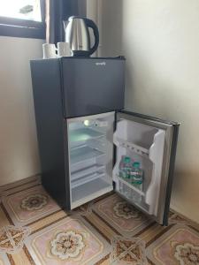 a refrigerator with its door open in a room at Forge boutique in Chiang Mai
