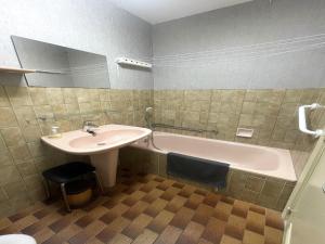 a bathroom with a sink and a bath tub at Apartment with Pool and Sea View in Middelkerke