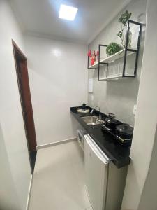 a small kitchen with a sink and a stove at Seja Bem-Vindos, sinta-se em Casa ! in São Lourenço +9 photos