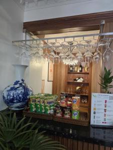 a counter with a bunch of wine glasses and food at Cozy 86 Homestay in Can Tho