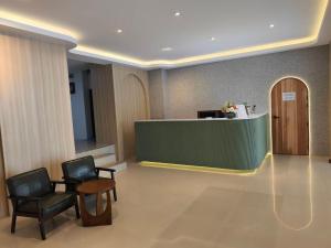 a lobby with two chairs and a reception desk at P.K. Mansion in Ao Nang Beach