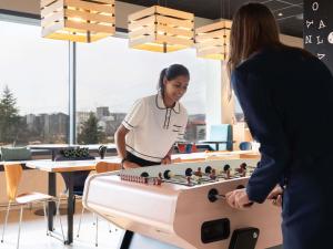 two women playing a game of chess in an office at ibis Styles Geneve Palexpo Aeroport in Geneva
