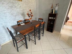 a dining room table with chairs and a vase with flowers on it at Swiss Home in Agadir +21 photos